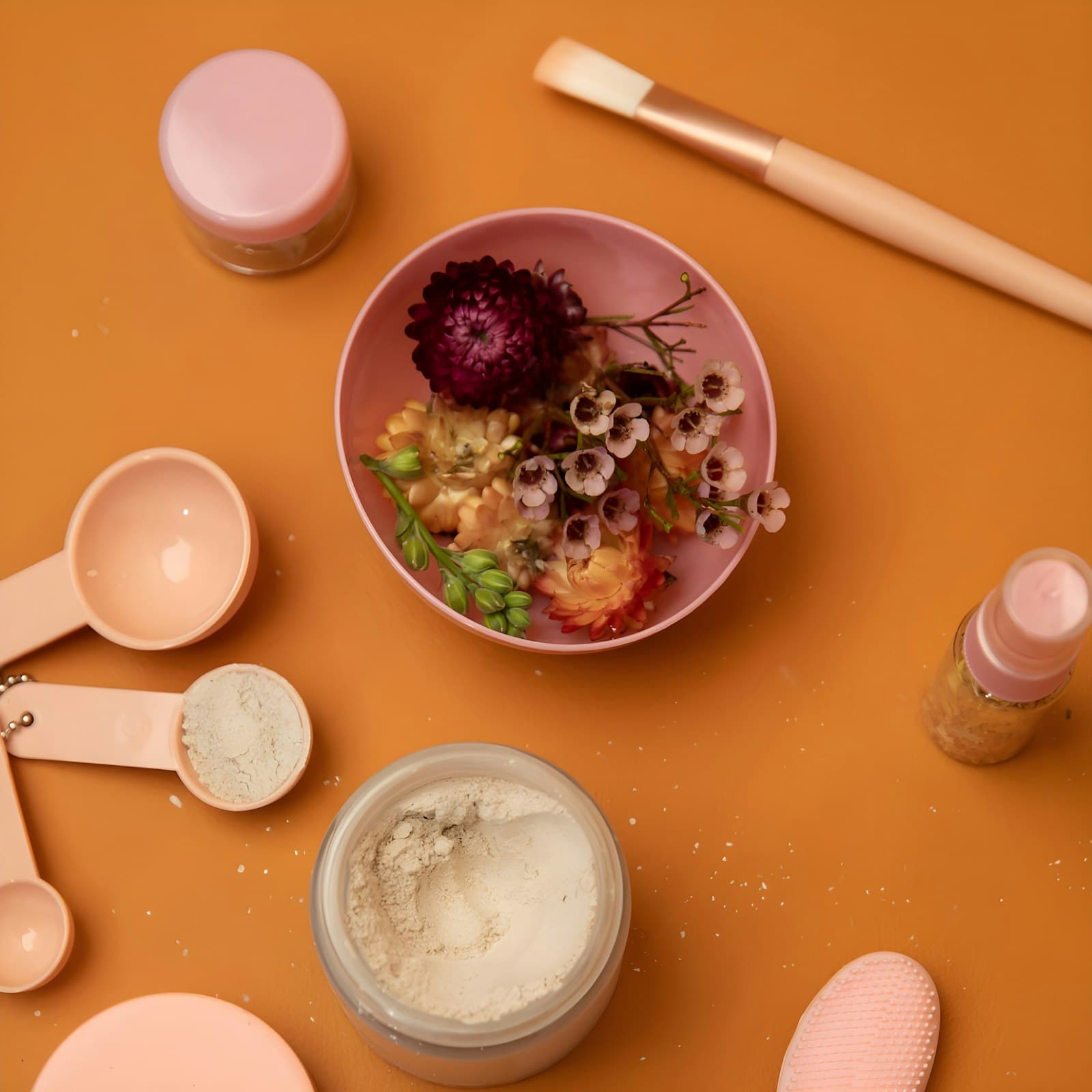 Flat-lay of botanicals, argan, rose, rhassoul, and saffron
