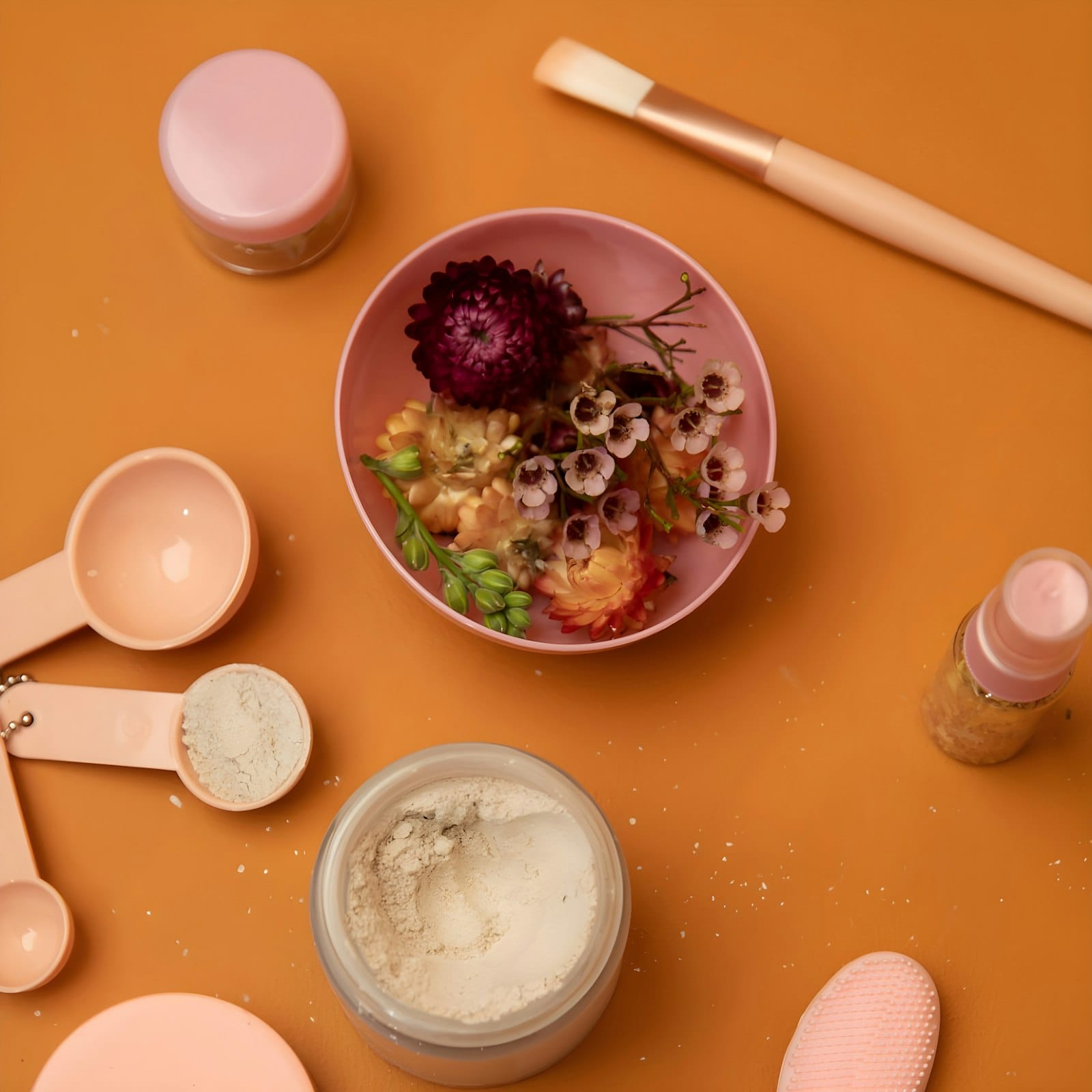 Flat-lay of botanicals — argan, rose, rhassoul, saffron